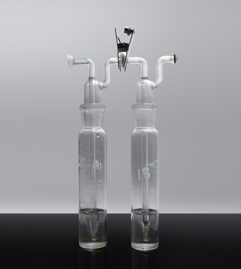 Two glass gas impingers (bubblers) used downstream of the UVM to capture vapor into solution for chemical analysis